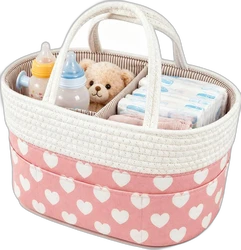 Roze luiertafel-organizer met hartjes en vakken Roze en witte touwmand met hartjes, handvatten, babyflessen, luiers en teddybeer in vakken