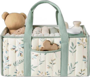 Gewatteerde luiermand met saliegroene hengsels, bladprint en zichtbare babyspullen.