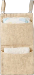 Beige hangende babybedorganizer met twee vakken Beige mousseline babybedorganizer met twee ophanglussen, luier en doek in twee vakken