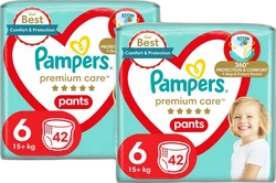 Twee turquoise verpakkingen Pampers Premium Care Pants maat 6 met 42 luierbroekjes en kind op de voorkant.